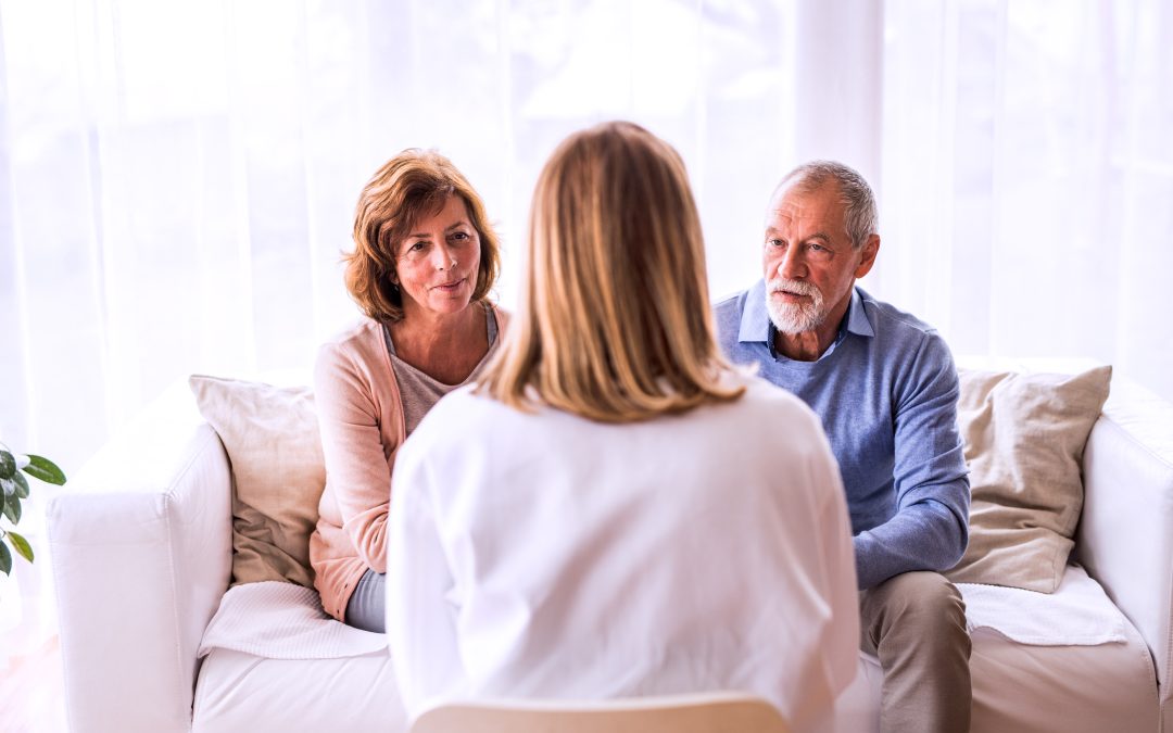 Female doctor talking to a senior couple in Marriage Counseling EFT Therapy